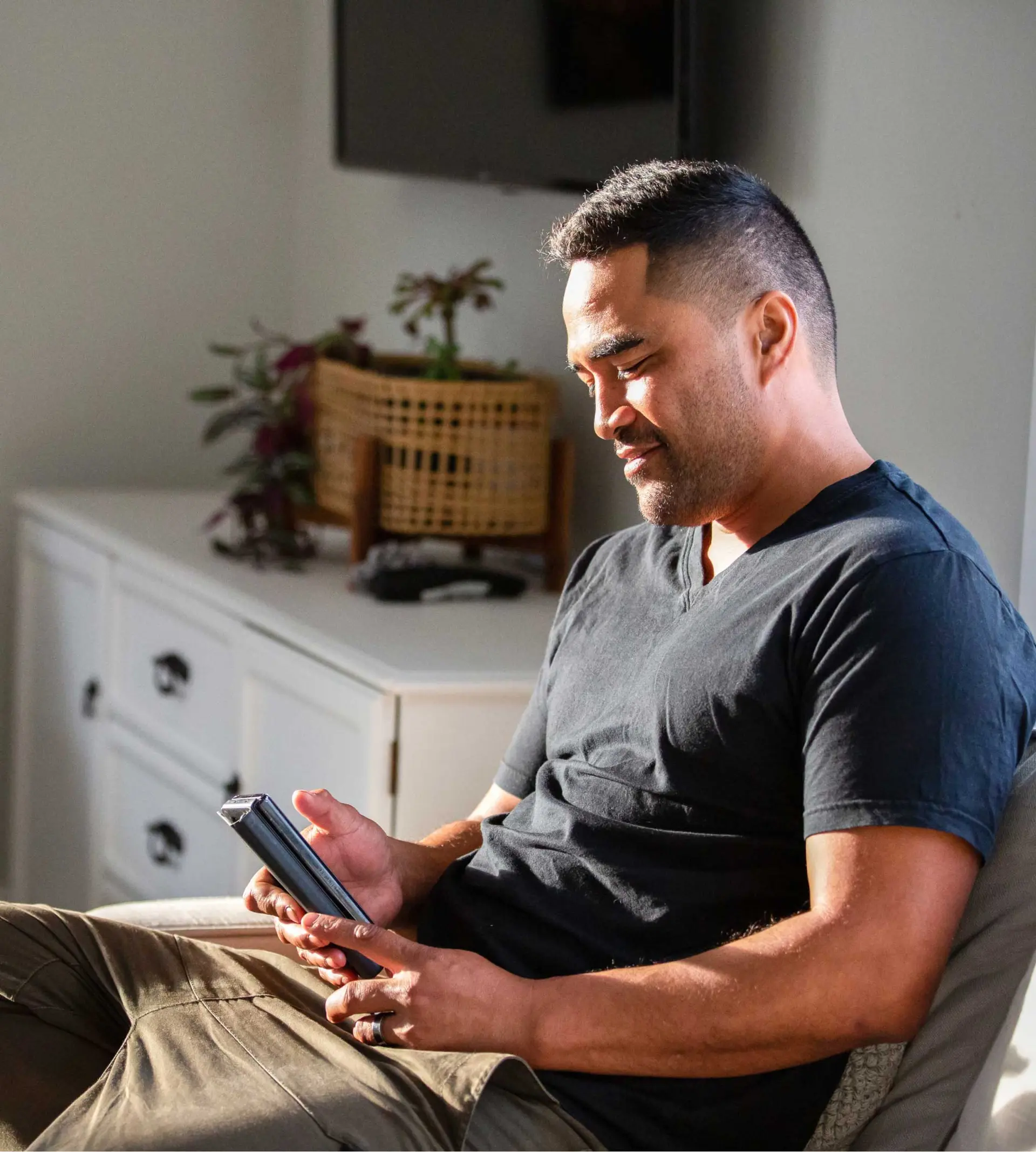 Man sitting down looking at his phone
