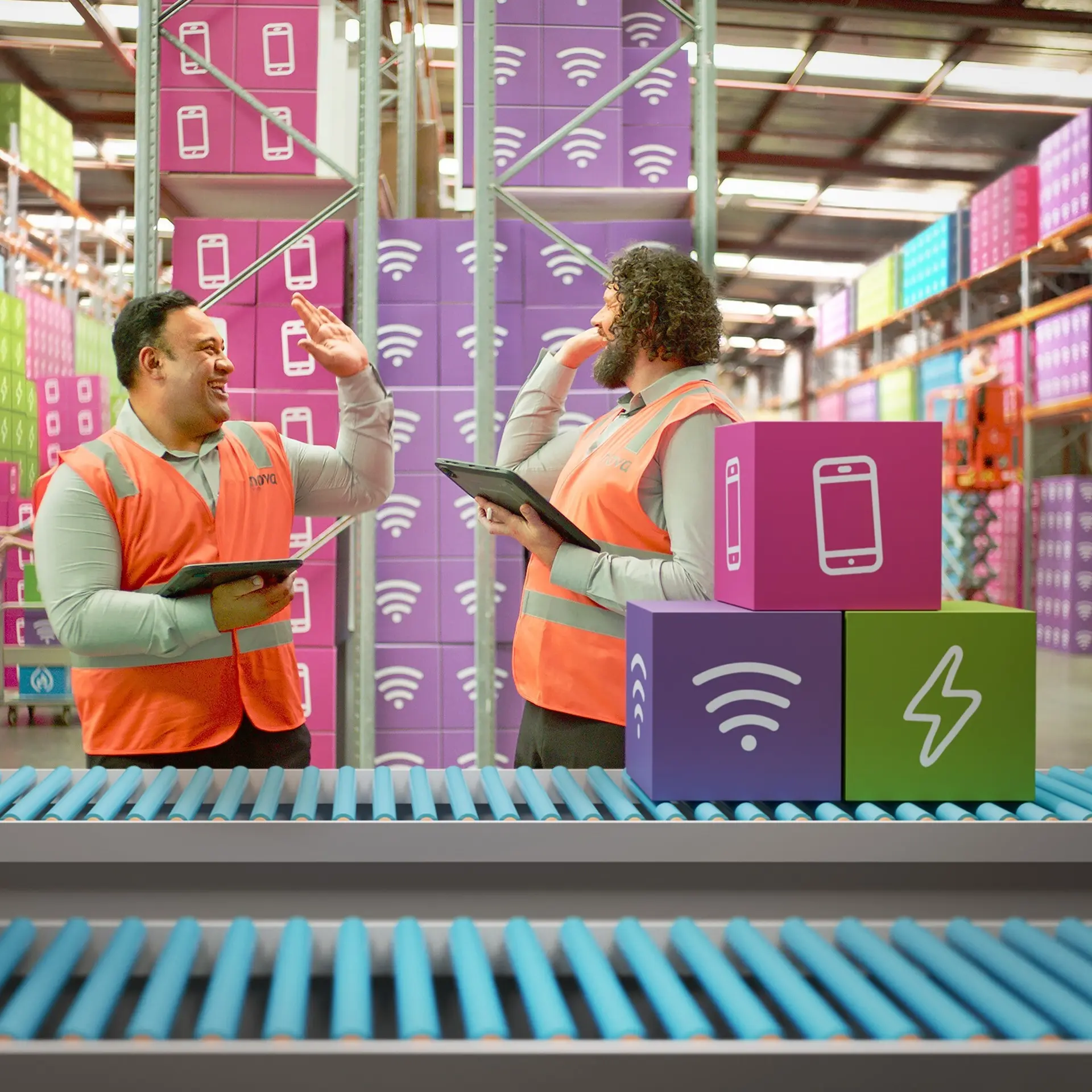 Two warehouse workers using tablets beside a conveyor belt in a distribution warehouse.