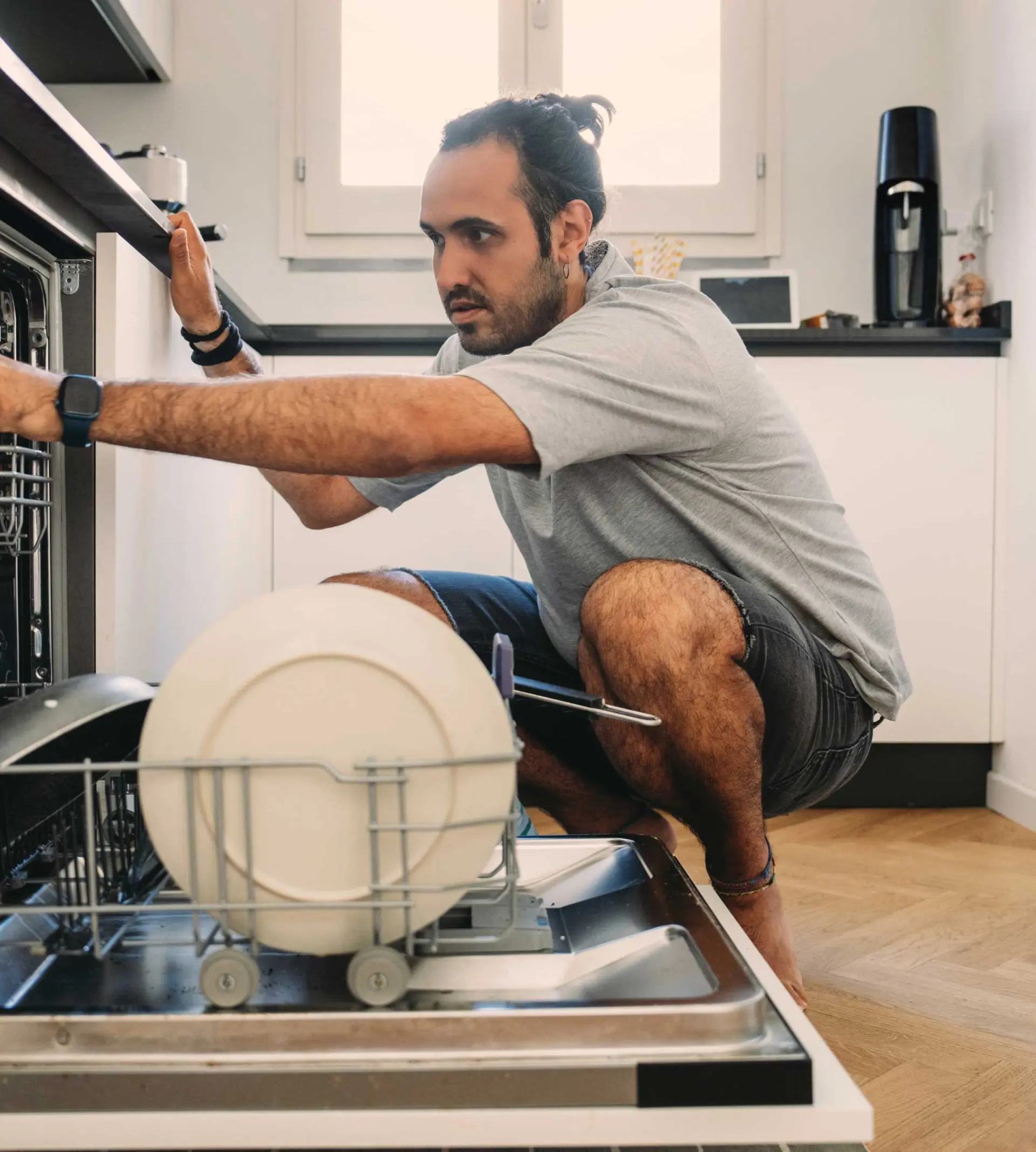 Man looking into the dishwasher
